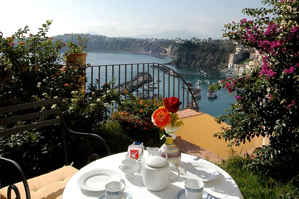 Breakfast served on the terrace of La Casa sul Mare, looking over the bay of Corricella