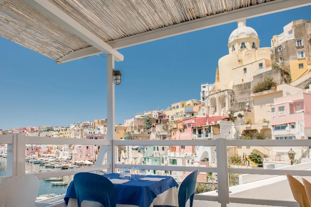 The covered terrace at La Lampara, looking over the harbour and the houses of Corricella