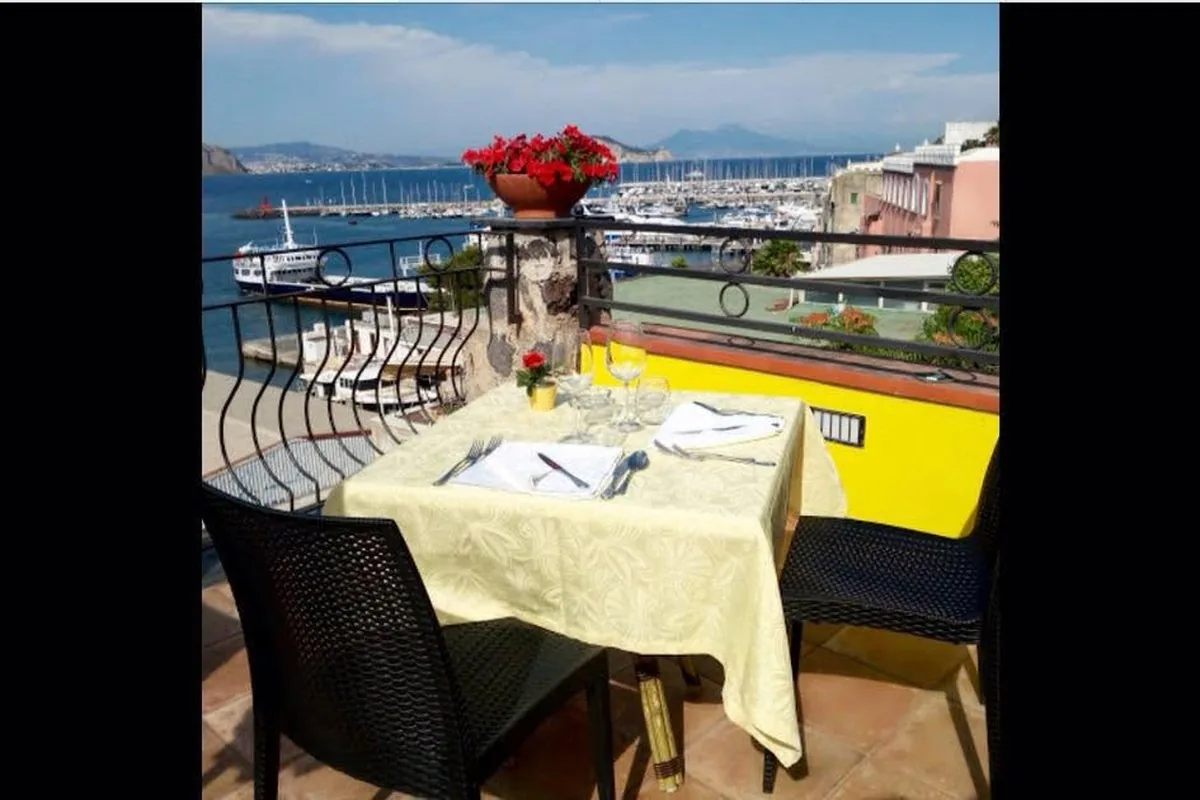 A table laid on the terrace at Re Ferdinando, with the view over the harbour